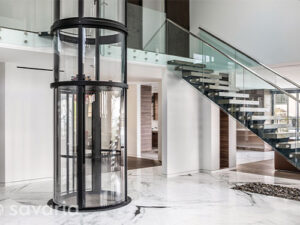 Savaria Home Elevator in Middle of Entry Way with Stairs in Naperville, Peoria, Kankakee, Bloomington, Schaumburg, and Hinsdale