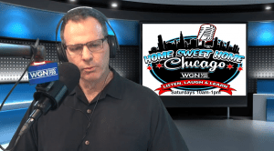 A man wearing headphones speaks into a microphone in a radio studio. Behind him is a screen displaying the Home Sweet Home Chicago WGN 720 logo and show details: Saturdays 10am–1pm.