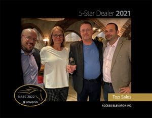 Four people stand together, smiling, while one person in the center holds a small star-shaped award. The image highlights the 5-Star Dealer 2021 and Top Sales awards for Access Elevator Inc.