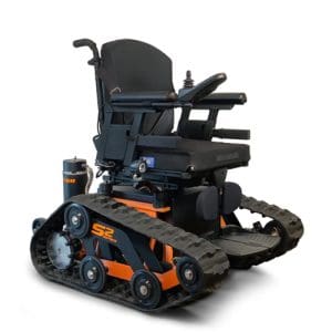 A black and orange all-terrain electric wheelchair with tank-like rubber tracks instead of wheels, designed for enhanced mobility over rough surfaces. The chair has armrests, a cushioned seat, and a joystick control.