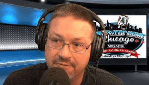 A man wearing glasses and large headphones speaks into a microphone in a radio studio. Behind him, a screen displays the logo for Sweet Home Chicago on WGN 720, along with show details.