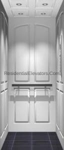 A modern residential elevator interior with white paneled walls, recessed lighting in the ceiling, a metal handrail, and a dark tiled floor.