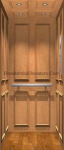 A small, wood-paneled residential elevator with recessed lighting in the ceiling and a silver handrail on the back wall.