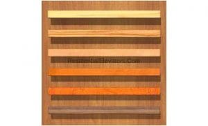 A wooden board displays seven horizontal strips of wood in varying colors and grain patterns, showcasing different wood finishes or types.