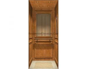 A small residential elevator interior with wood paneling, a built-in mirror, recessed ceiling lights, and a light-colored floor mat.