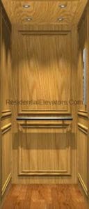 Interior of a small residential elevator with light wood-paneled walls, wood flooring, a horizontal handrail, and recessed ceiling lights.