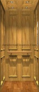 Interior view of a residential elevator with wood panel walls, recessed lighting in the ceiling, decorative moldings, and a polished wood floor.
