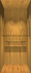 Wood-paneled residential elevator interior with overhead lights, a handrail on the back wall, and wood flooring.