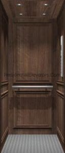 Small residential elevator interior with dark wood paneling, a horizontal handrail, recessed ceiling lights, and a patterned gray floor.