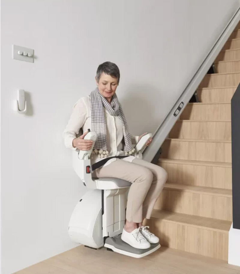 User Demonstrating Ease of Use of Foldable Armrests on Access BDD HomeGlide Straight Stair Lift