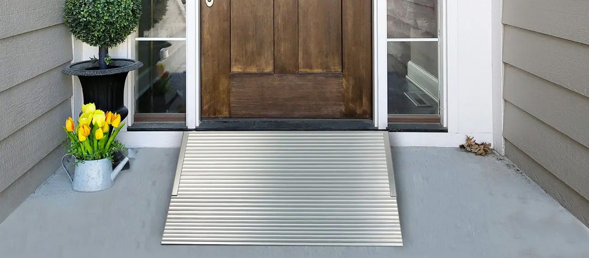 Aluminum Threshold Ramp from National Ramps. Ramp is at home's door with potted plants