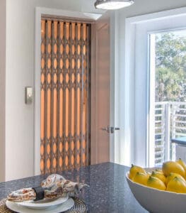 Elegant Elevator Door in Background with Bowl of Fruit in Foreground