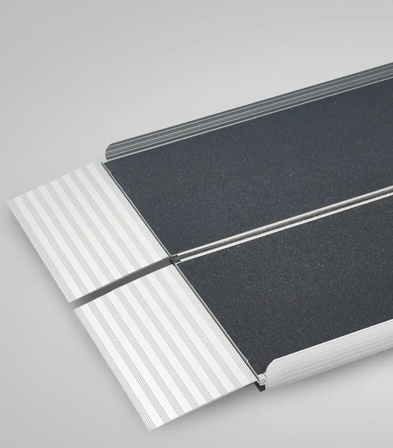 Bi-fold aluminum portable wheelchair ramp from National Ramps unfolded and ready to use.