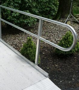 Residential wheelchair ramp with mesh aluminum decking, designed to maintain optimal traction in snowy climates.