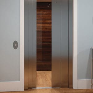 A partially open Eclipse Elevator by Savaria with stainless steel doors reveals wood panel walls and a hardwood floor, set within a light gray wall and sleek white frame in this modern home.