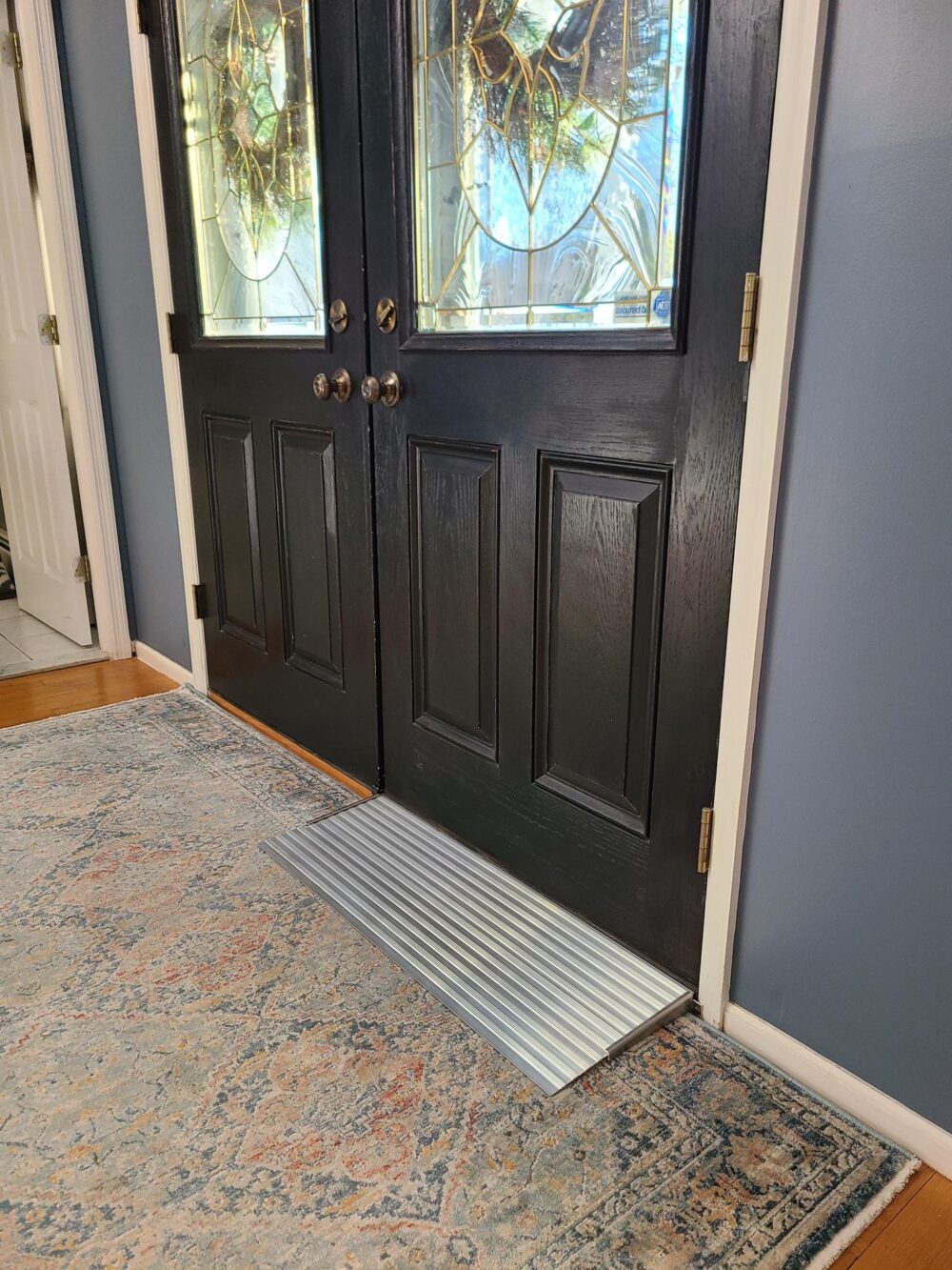 Small aluminum modular threshold ramp from National Ramps, providing easy wheelchair access to front door