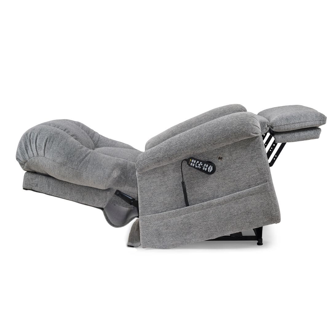 A gray upholstered lift recliner is fully extended, with backrest tilted and footrest raised, showing a side control panel—offering comfort like the Cloud with Twilight & Optional Nirvana Medium/Large by Golden Technologies.