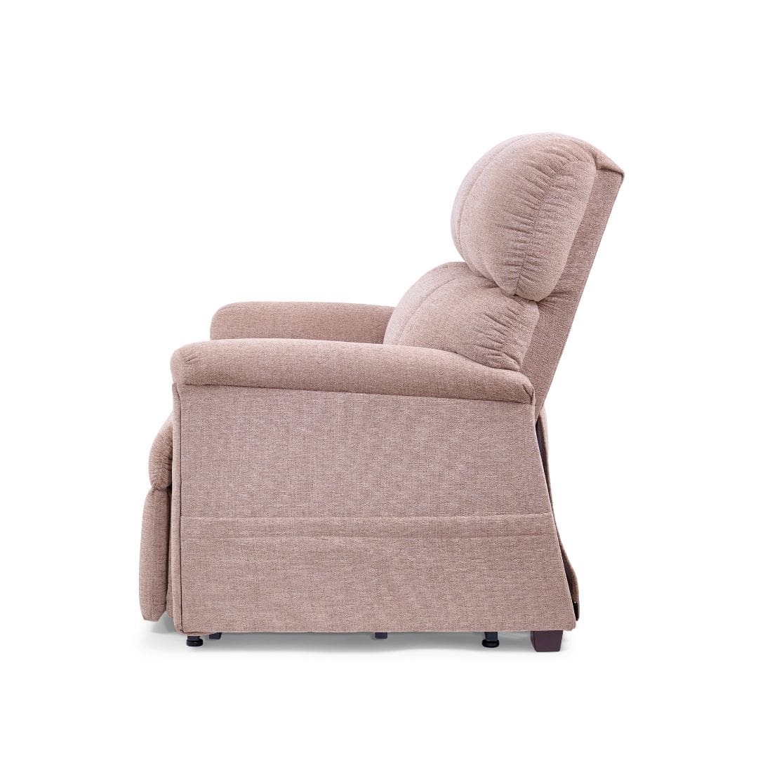 Side view of the Comforter Medium Wide - Lift Chair by Golden Technologies in beige upholstery, featuring padded armrests, a high backrest, and footrest, set against a plain white background. Side view of the Comforter Medium Wide - Lift Chair by Golden Technologies in beige upholstery, featuring padded armrests, a high backrest, and footrest, set against a plain white background.