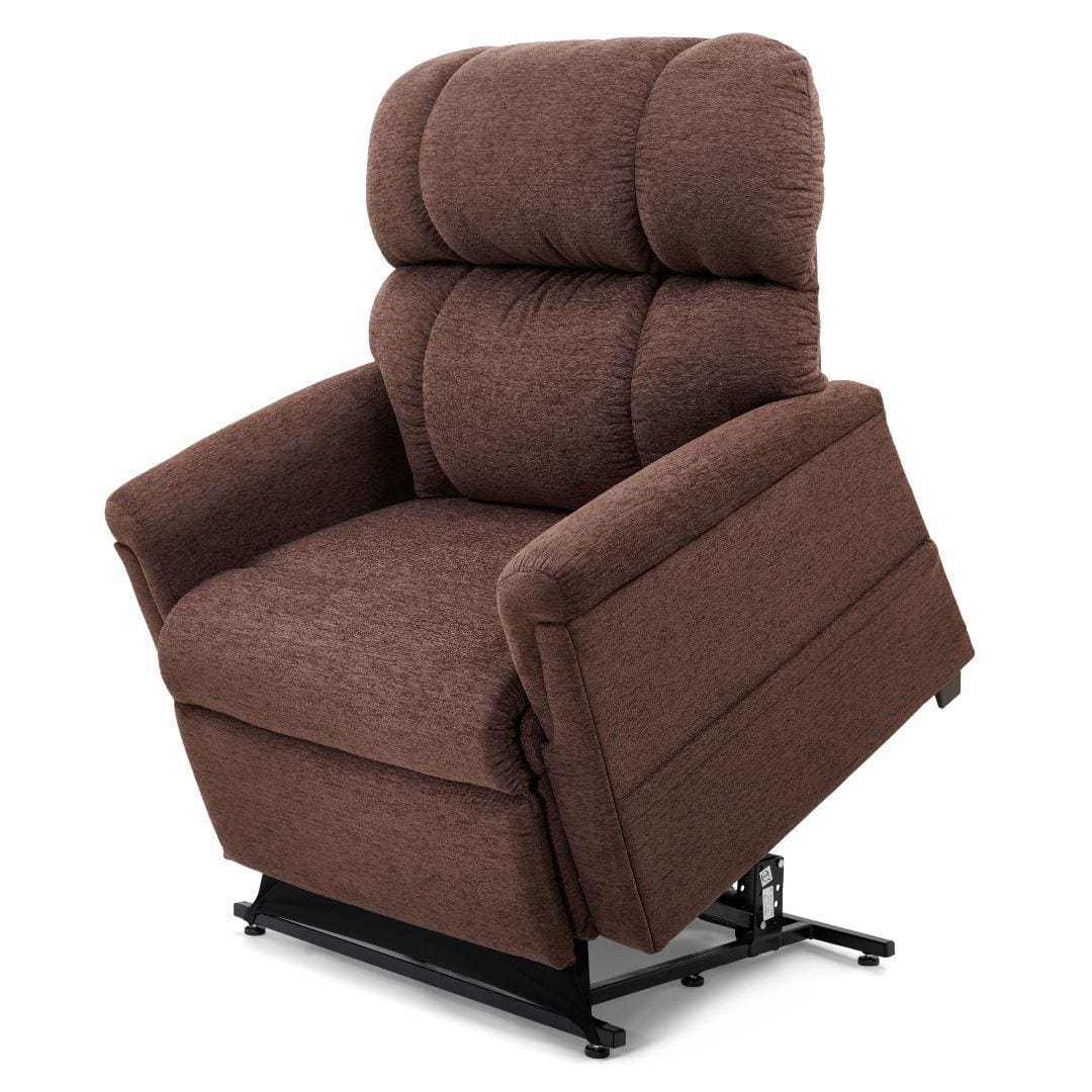 The Comforter with MaxiComfort Large/Wide Lift Chair by Golden Technologies, shown in brown upholstery with plush cushions, features a black metal base that lifts partially to assist users in standing up. The Comforter with MaxiComfort Large/Wide Lift Chair by Golden Technologies, shown in brown upholstery with plush cushions, features a black metal base that lifts partially to assist users in standing up.