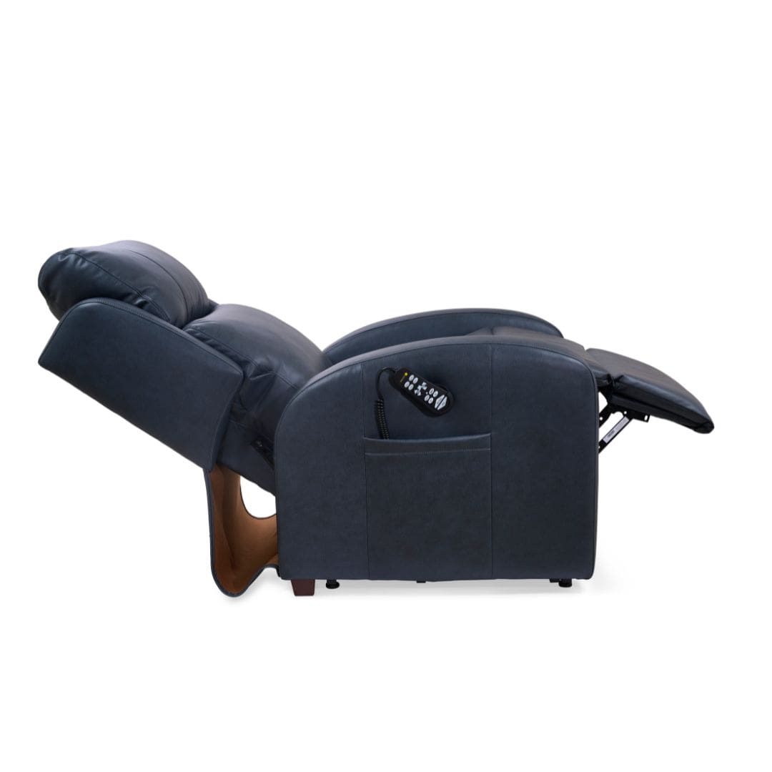 The EZ Sleeper Slim Lift Chair by Golden Technologies in dark blue is shown fully reclined with the footrest extended, featuring a remote control stored in its side pocket. The EZ Sleeper Slim Lift Chair by Golden Technologies in dark blue is shown fully reclined with the footrest extended, featuring a remote control stored in its side pocket.
