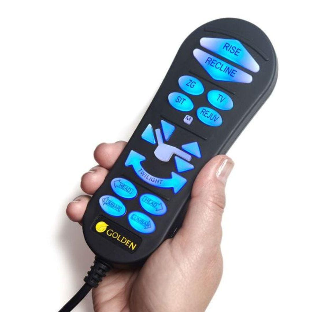 A hand holds the “GOLDEN”-branded remote with blue backlit buttons for rise, recline, sit, TV, and Twilight—ideal for adjusting your EZ Sleeper with Twilight Medium/Large Lift Chair by Golden Technologies.