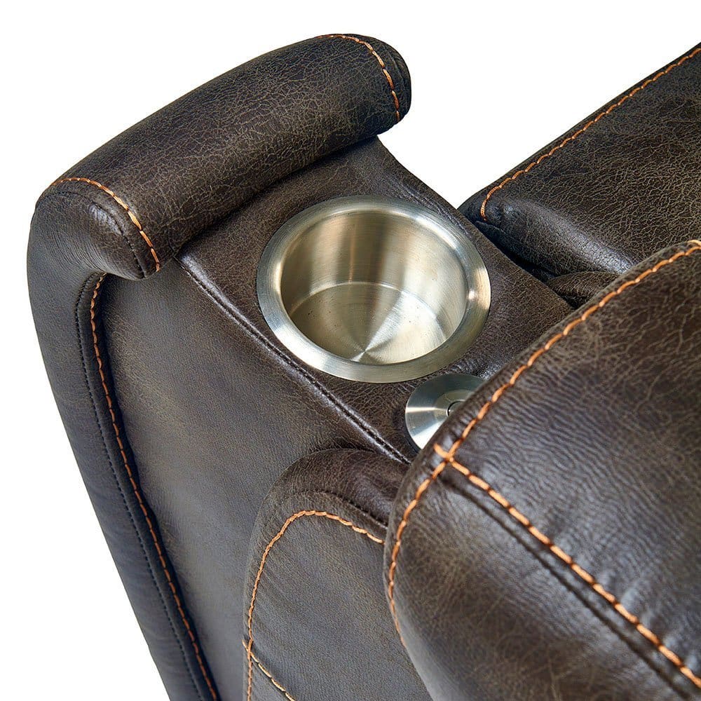 Close-up of the Titan Medium - Lift Chair by Golden Technologies armrest in dark brown leather with orange stitching, featuring a built-in metal cup holder. Close-up of the Titan Medium - Lift Chair by Golden Technologies armrest in dark brown leather with orange stitching, featuring a built-in metal cup holder.