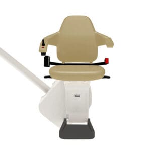 The Freecurve Curved Stair Lift by Handicare features a beige chair with armrests, seatbelt, footrest, and joystick control, mounted on a white rail for safe and convenient stair lift installation on curved stairs.