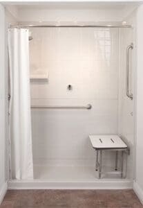 The Walk-In Shower by BestBath features white tile, a white curtain, horizontal and right-wall grab bars, an L-shaped folding shower chair, and a corner shelf for a comfortable, accessible bathing experience.