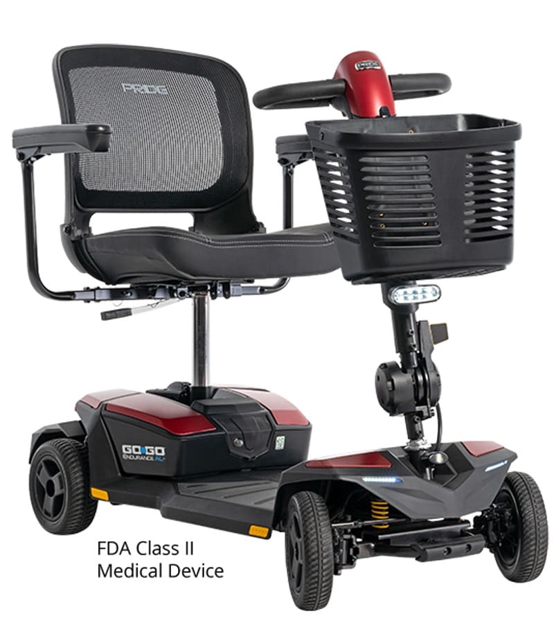 The Go Go Endurance AL+-Wheel Scooter by Pride Mobility is a red and black heavy-duty four-wheel mobility scooter with a mesh-backed seat, armrests, front basket, and is classified as an FDA Class II medical device. The Go Go Endurance AL+-Wheel Scooter by Pride Mobility is a red and black heavy-duty four-wheel mobility scooter with a mesh-backed seat, armrests, front basket, and is classified as an FDA Class II medical device.