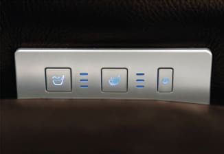 Close-up of the VivaLift Premier - PLR-5900 Lift Chair’s control panel, featuring illuminated buttons for seat ventilation, heating, and power adjustment—highlighting the advanced comfort functions by Pride Mobility.