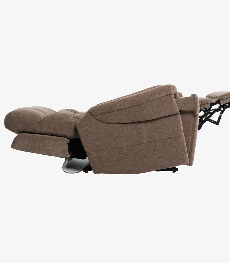 The VivaLift Ultra - PLR-4955 Lift Chair by Pride Mobility, shown fully reclined in brown fabric, displays its padded seat, backrest, and footrest horizontally against a white background. The VivaLift Ultra - PLR-4955 Lift Chair by Pride Mobility, shown fully reclined in brown fabric, displays its padded seat, backrest, and footrest horizontally against a white background.