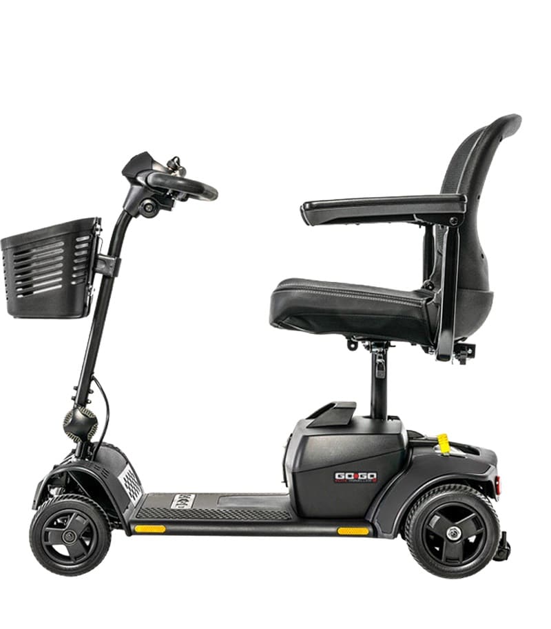 The Go Go Elite Traveller 2-Wheel Scooter by Pride Mobility is a black electric scooter with a front basket, adjustable armrests, and a cushioned seat, shown in profile facing left on a white background for easy daily mobility.