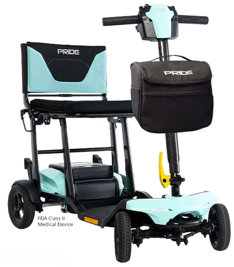 The Go Go Super Portable 3-Wheel Scooter by Pride Mobility is a lightweight teal and black outdoor scooter with a mesh backrest, front storage bag, three wheels, and an FDA Class II medical device label. The Go Go Super Portable 3-Wheel Scooter by Pride Mobility is a lightweight teal and black outdoor scooter with a mesh backrest, front storage bag, three wheels, and an FDA Class II medical device label.