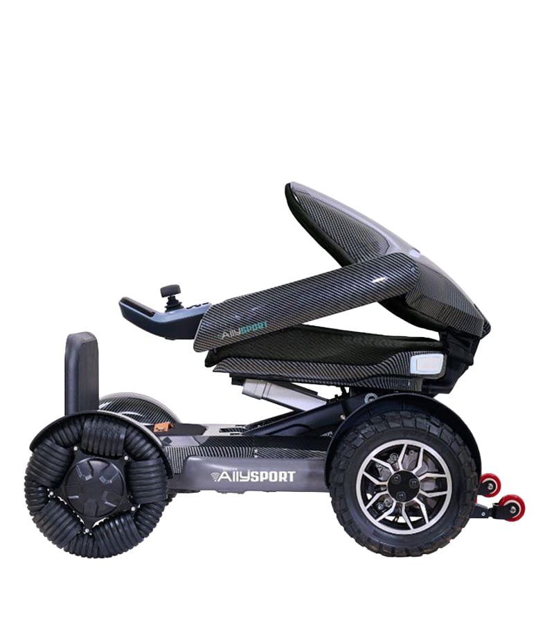 Side view of the Ally Sport - Power Wheelchair by Golden, a modern, compact travel wheelchair with large rugged wheels and a sleek black carbon fiber frame labeled “AiLysport,” featuring an angled seat and joystick controller. Side view of the Ally Sport - Power Wheelchair by Golden, a modern, compact travel wheelchair with large rugged wheels and a sleek black carbon fiber frame labeled “AiLysport,” featuring an angled seat and joystick controller.