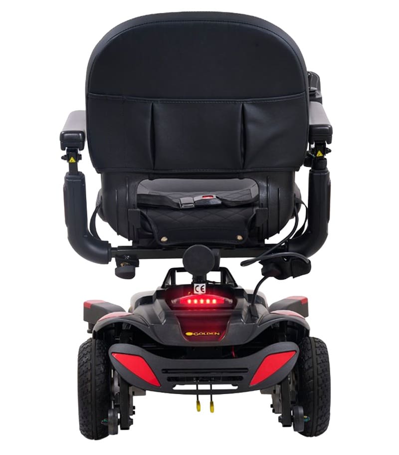 Rear view of a black BuzzAbout - Power Wheelchair by Golden featuring a cushioned seat, armrests, storage pouch, and taillights. This four-wheel power wheelchair is ideal for senior mobility and personal transportation. Rear view of a black BuzzAbout - Power Wheelchair by Golden featuring a cushioned seat, armrests, storage pouch, and taillights. This four-wheel power wheelchair is ideal for senior mobility and personal transportation.