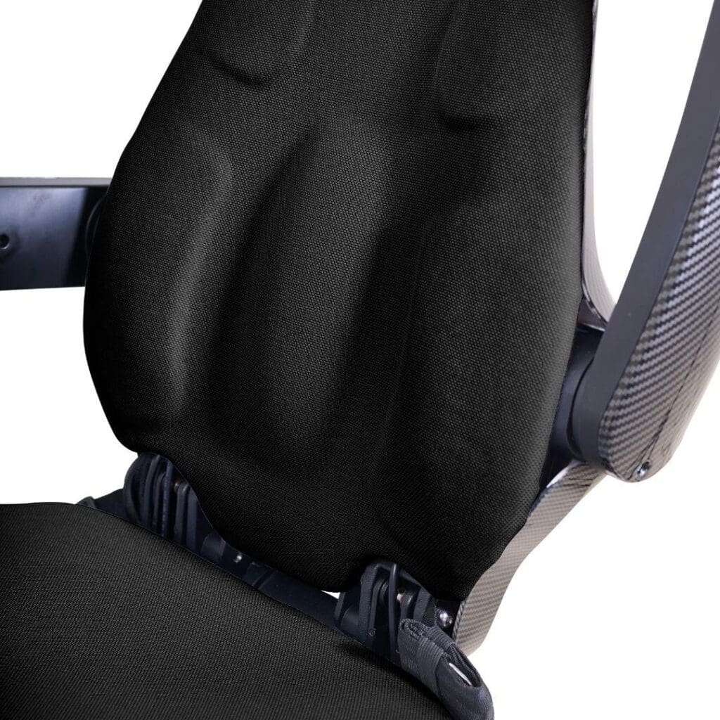 Close-up of a black racing-style seat with contoured padding, visible seatbelt buckles, and carbon fiber-textured sides—ideal for the Ally Sport - Power Wheelchair by Golden, combining comfort with a sleek design.