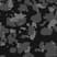 A close-up image of a camouflage pattern with irregular shapes in black, grey, and dark green, inspired by the rugged aesthetic of the PX4 4-Wheel Scooter by Pride Mobility.