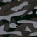 Close-up of a black, grey, and white camouflage pattern with irregular shapes—ideal for giving the PX4 4-Wheel Scooter by Pride Mobility a rugged, stylish look.