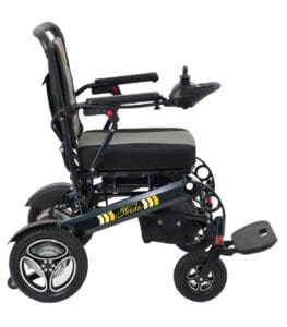 Side view of the Stride - Power Wheelchair by Golden, a portable black and gray chair with joystick control on the right armrest, cushioned seat, three large wheels, and a front footrest.