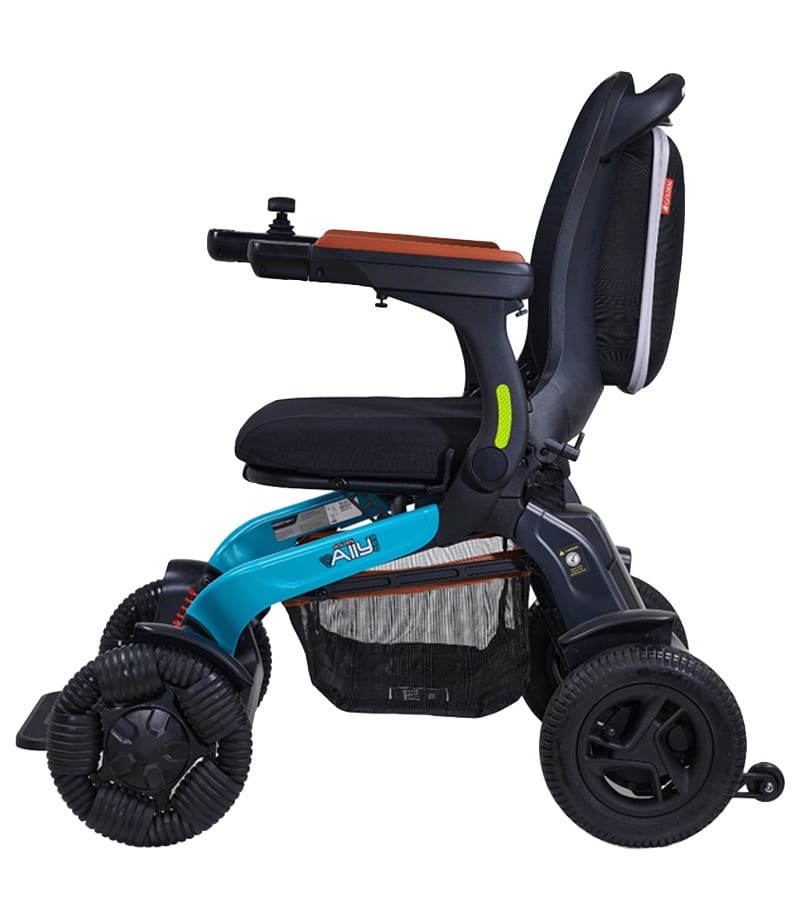 The Ally Pro - Power Wheelchair by Golden features a lightweight turquoise frame, black seat, large treaded front wheels, right-arm joystick control, armrests, and a storage pouch for compact travel convenience. The Ally Pro - Power Wheelchair by Golden features a lightweight turquoise frame, black seat, large treaded front wheels, right-arm joystick control, armrests, and a storage pouch for compact travel convenience.