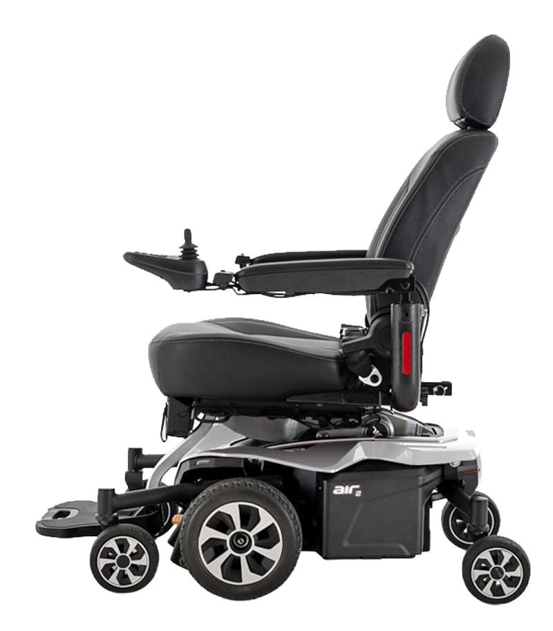 The Jazzy Air 2 Power Wheelchair by Pride Mobility is a modern chair with a cushioned seat, headrest, armrests, joystick control, and features four large wheels plus two smaller front wheels for stability and mobility. The Jazzy Air 2 Power Wheelchair by Pride Mobility is a modern chair with a cushioned seat, headrest, armrests, joystick control, and features four large wheels plus two smaller front wheels for stability and mobility.