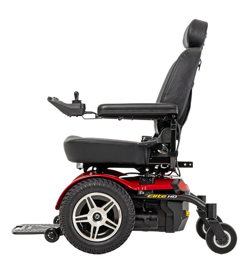 A side view of the Jazzy Elite 14 Power Wheelchair by Pride Mobility in red and black, featuring a cushioned seat, adjustable armrests, headrest, large rear wheels, and an extended footrest for comfort and easy use.