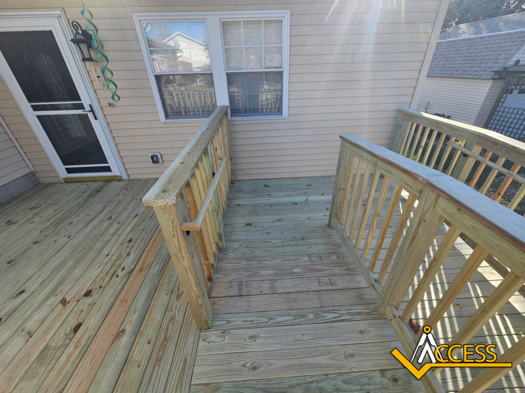 Custom wooden wheelchair ramp installed at a residential home in Colona, Illinois, featuring pressure-treated lumber, safety handrails, and a gradual incline designed to provide safe and reliable accessibility for wheelchair and mobility device users.