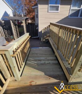 Custom wooden wheelchair ramp installed at a residential home in Colona, Illinois, featuring pressure-treated lumber, safety handrails, and a gradual incline designed to provide safe and reliable accessibility for wheelchair and mobility device users.