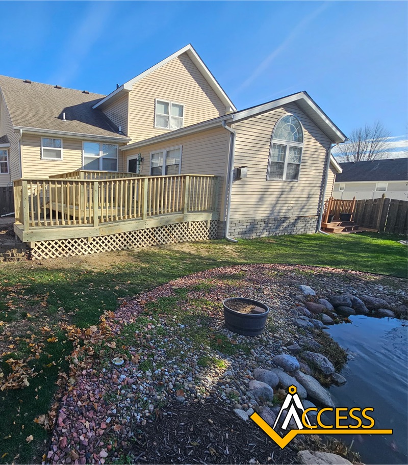 Custom wooden wheelchair ramp installed at a residential home in Colona, Illinois, featuring pressure-treated lumber, safety handrails, and a gradual incline designed to provide safe and reliable accessibility for wheelchair and mobility device users.