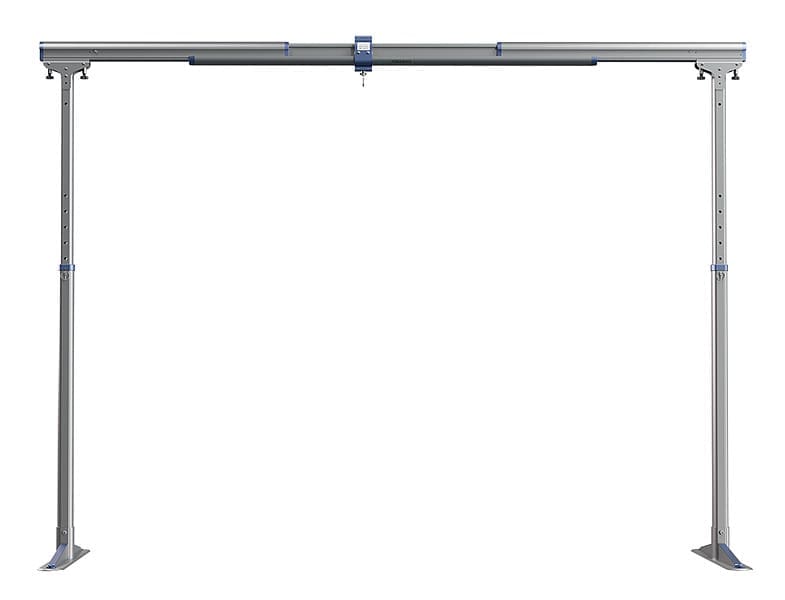 The FSG 440 Gantry by Mackworth is a freestanding metal system with two vertical legs, a horizontal beam, and an adjustable central bracket, designed as a mobile ceiling lift for supporting loads. Shown against a plain white background. The FSG 440 Gantry by Mackworth is a freestanding metal system with two vertical legs, a horizontal beam, and an adjustable central bracket, designed as a mobile ceiling lift for supporting loads. Shown against a plain white background.
