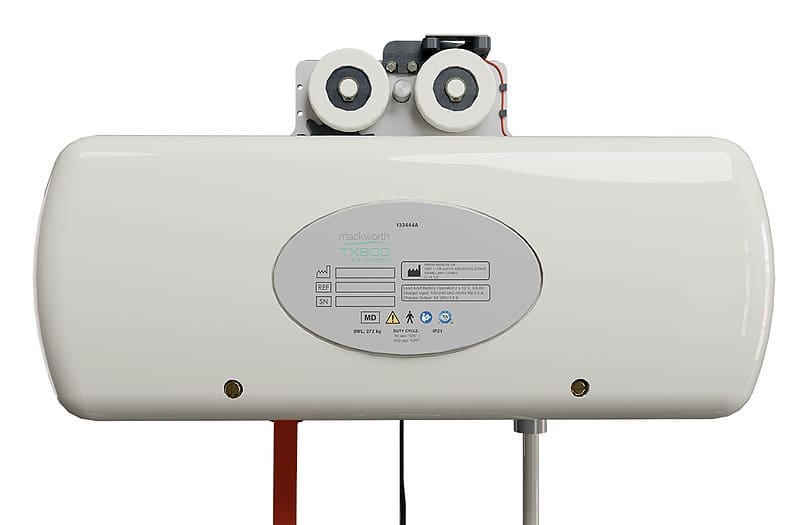 The Fixed Ceiling Lift by Mackworth is a white tankless unit with a front control panel and indicator labels, designed for use with systems like Surehands Home Care or overhead patient lifts. It features two downward pipe connections and black and red wires. The Fixed Ceiling Lift by Mackworth is a white tankless unit with a front control panel and indicator labels, designed for use with systems like Surehands Home Care or overhead patient lifts. It features two downward pipe connections and black and red wires.