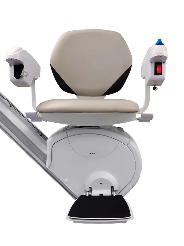 K2 Plus stairlift by Savaria seat option shown in a front-facing view, featuring a beige padded seat with fold-up armrests, integrated armrest controls, a swivel seat mechanism, and a black footrest mounted on a straight rail drive unit.