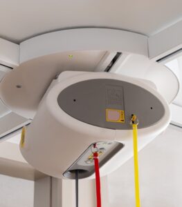 SureHands ceiling lift turntable mounted on an overhead track, allowing smooth 4-way track transitions for accessing multiple transfer locations in a home or healthcare setting.
