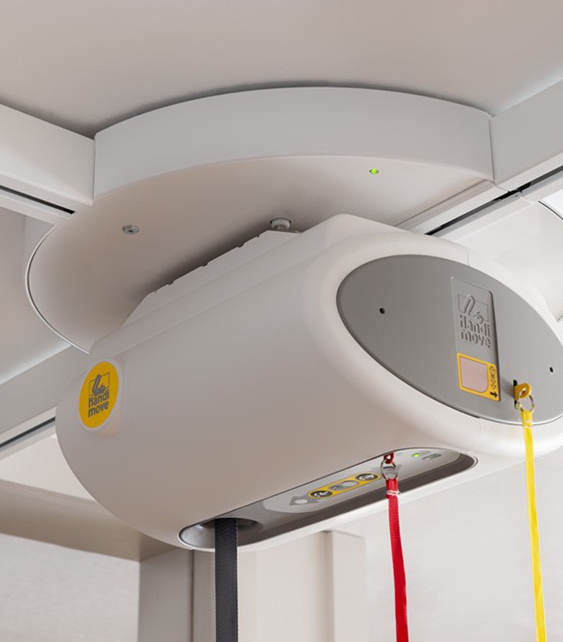 turntable-surehands-03 SureHands ceiling lift turntable mounted on an overhead track, allowing smooth 4-way track transitions for accessing multiple transfer locations in a home or healthcare setting.